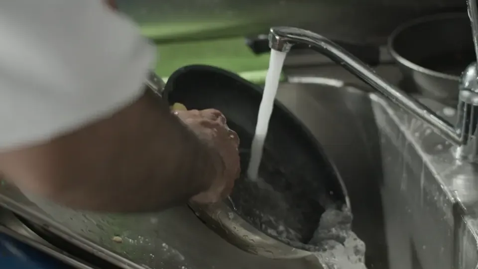 Washing a pan with soap and water
