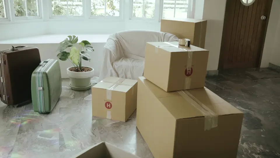 Packed moving boxes in an empty room